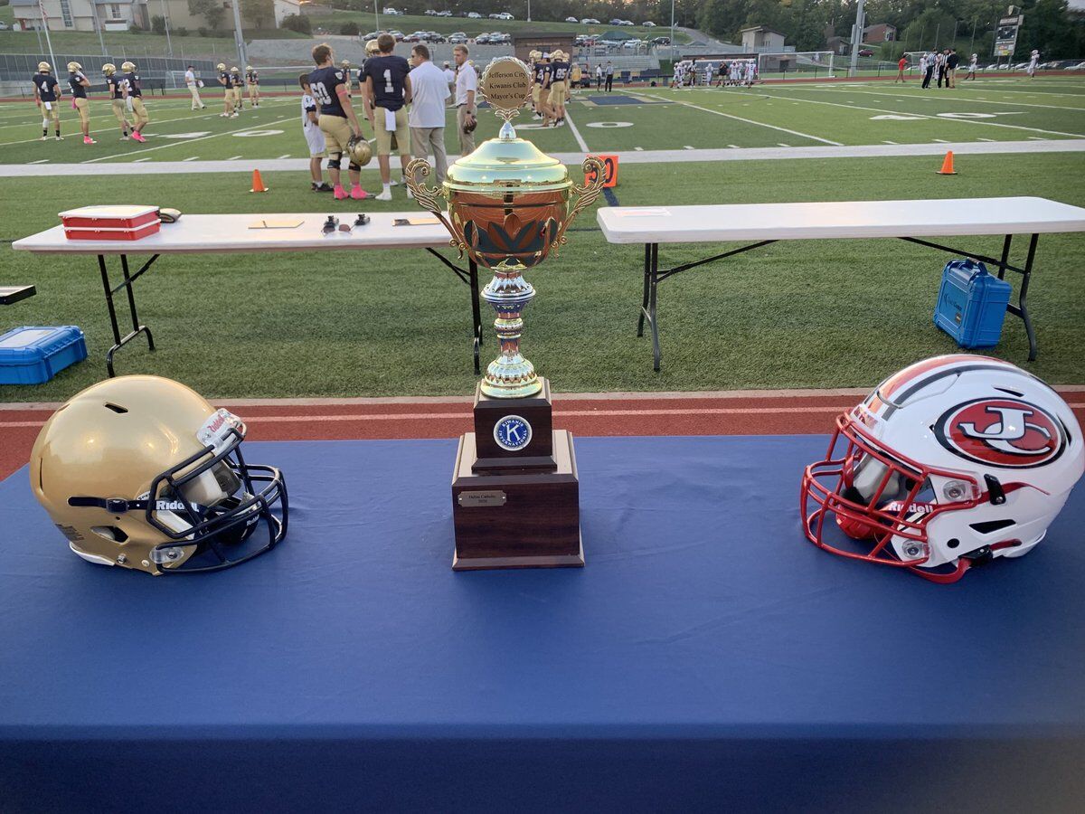 Jefferson City vs Helias helmets and trophy